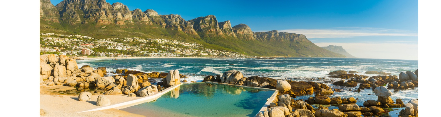Maidens Cove and camps Bay with Table Mountain and the Twelve Apostles mountains in the background, Cape Town, South Africa .Cape Town Tours Into Tours