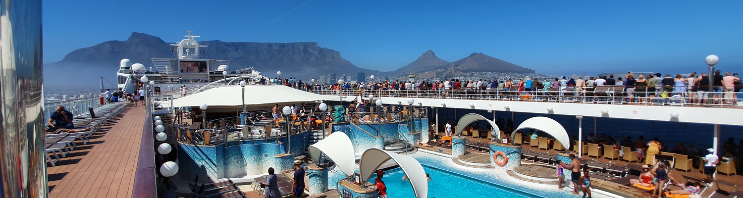 cruise ship passengers arriving to the cruise ship harbour terminal in Cape Town with a view of Table Mountain 